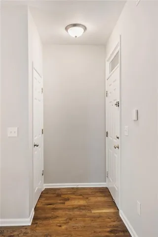 an empty room with wooden floor and closet