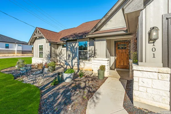 a view of a house with many windows next to a yard