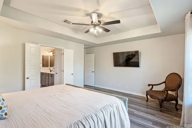 a spacious bedroom with a bed and a chandelier