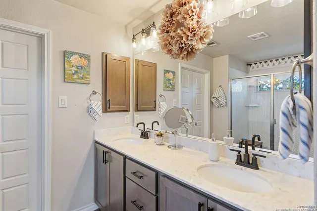a bathroom with a glass shower door