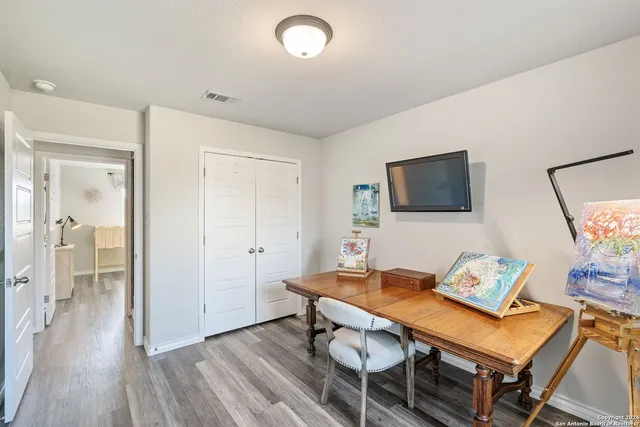 a living room with furniture a flat screen tv and a table