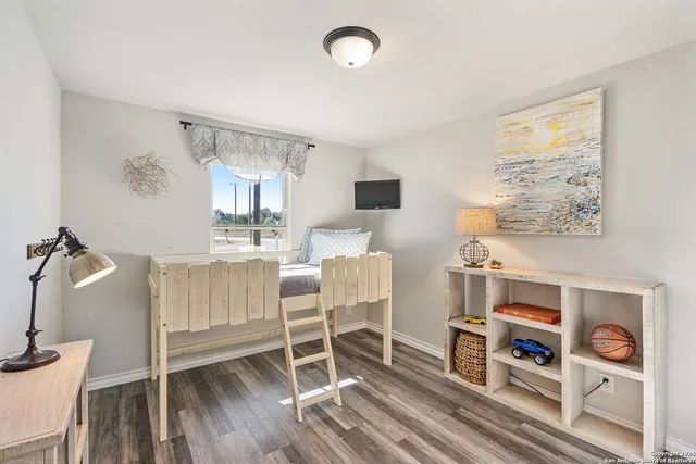 a room with a bed and a view of living room