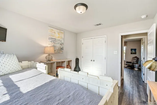 a bathroom with a granite countertop sink mirror toilet and bathtub
