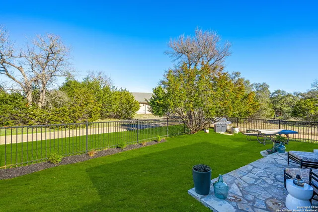 a view of yard with swimming pool and green space