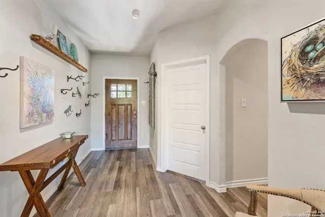 a living room with furniture a ceiling fan and a flat screen tv