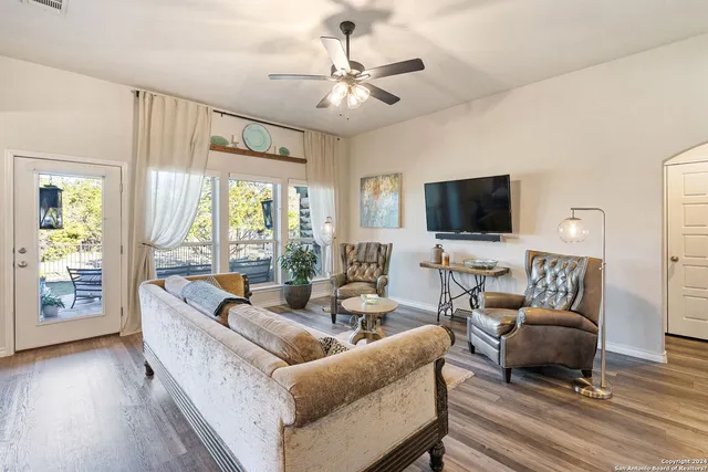 a living room with furniture a fireplace and a flat screen tv