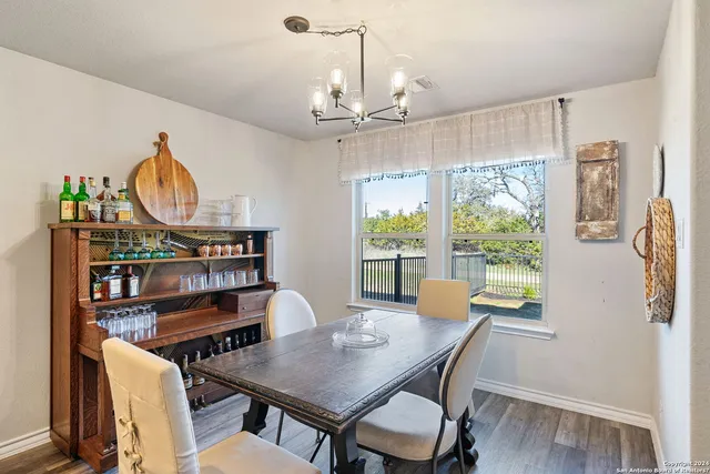 a bedroom with a bed chairs and a window