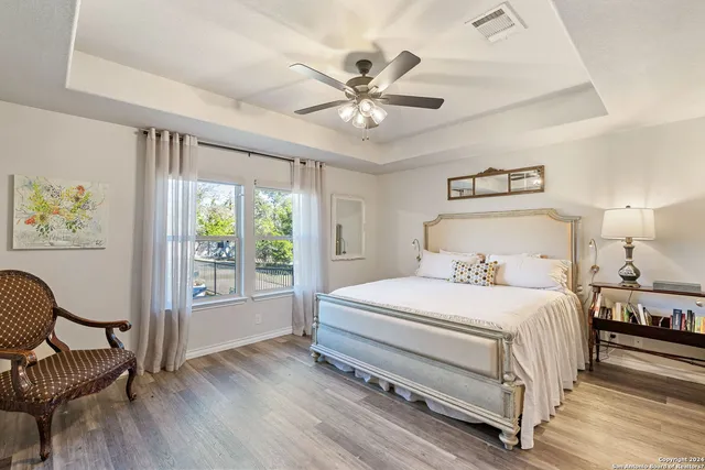 a bedroom with a bed and a flat tv screen on the dresser