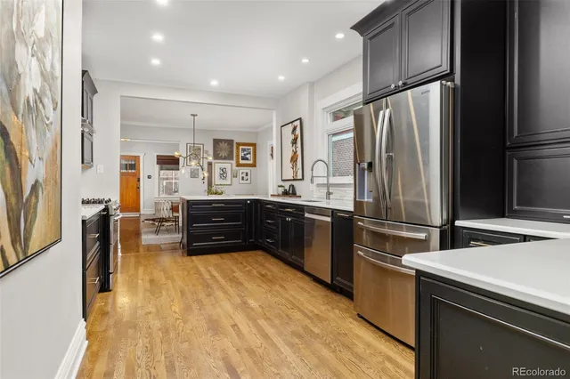 a kitchen with stainless steel appliances a refrigerator and a stove top oven