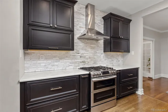 a kitchen with granite countertop cabinets stainless steel appliances and wooden floor