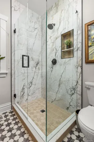 a bathroom with a shower and toilet