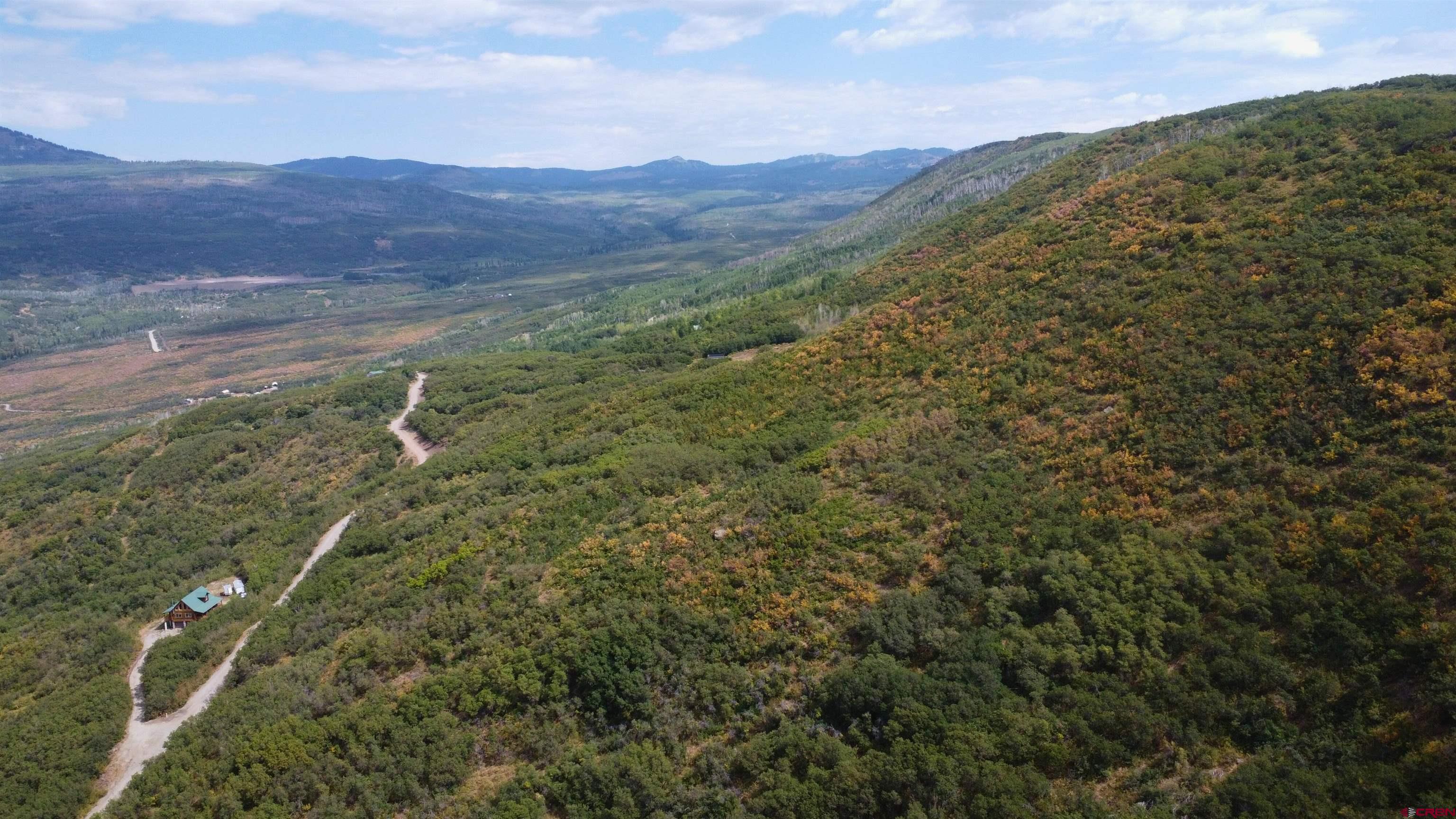 Lot 37 Stoney Creek Ranch Road Hotchkiss, CO 81419 - Photo 15 of 17 a view of a lush green hillside and a mountain