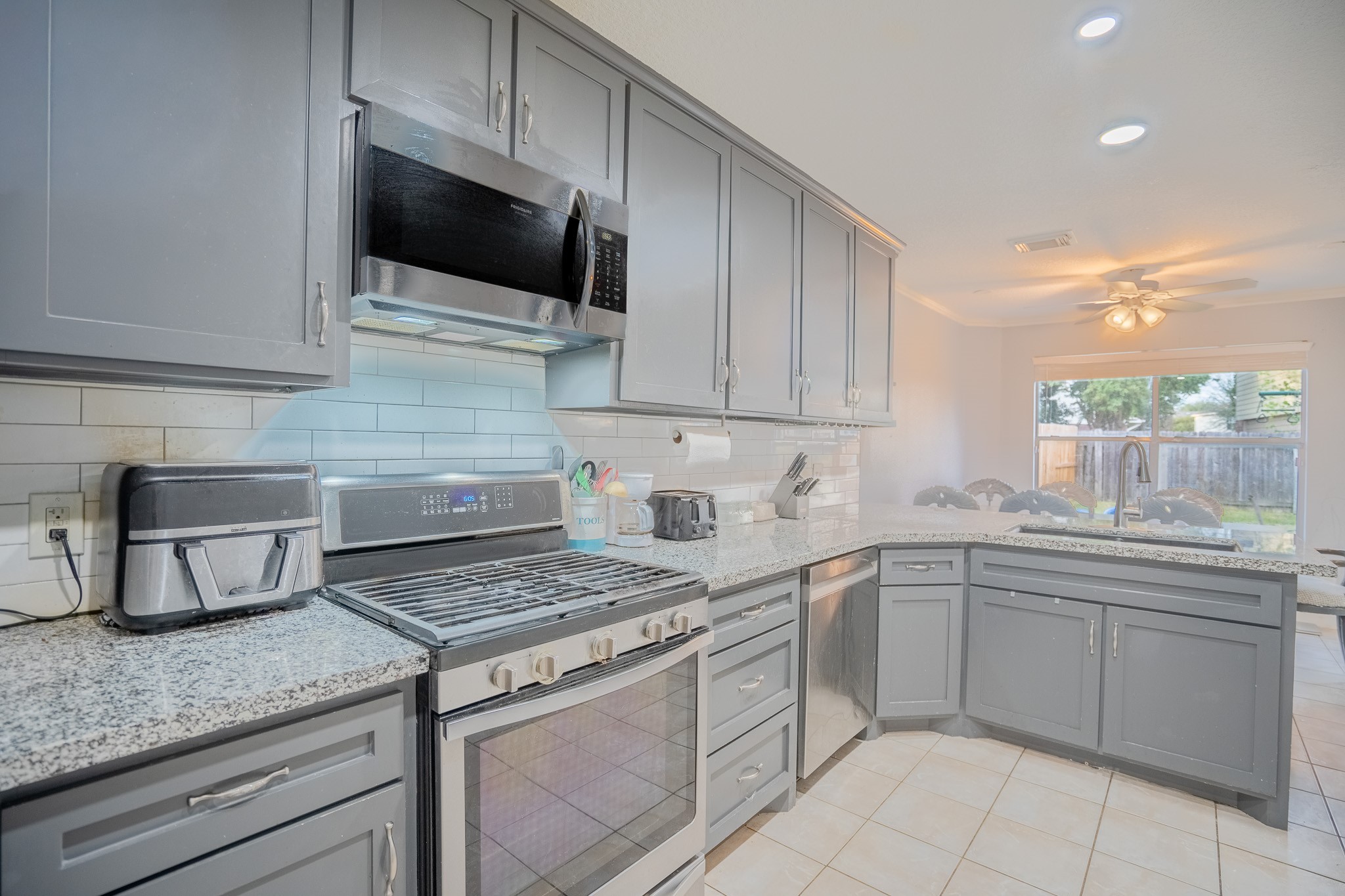 2322 Hadden Hollow Drive Houston, TX 77067 - Photo 11 of 28 a kitchen with a sink dishwasher stove and cabinets