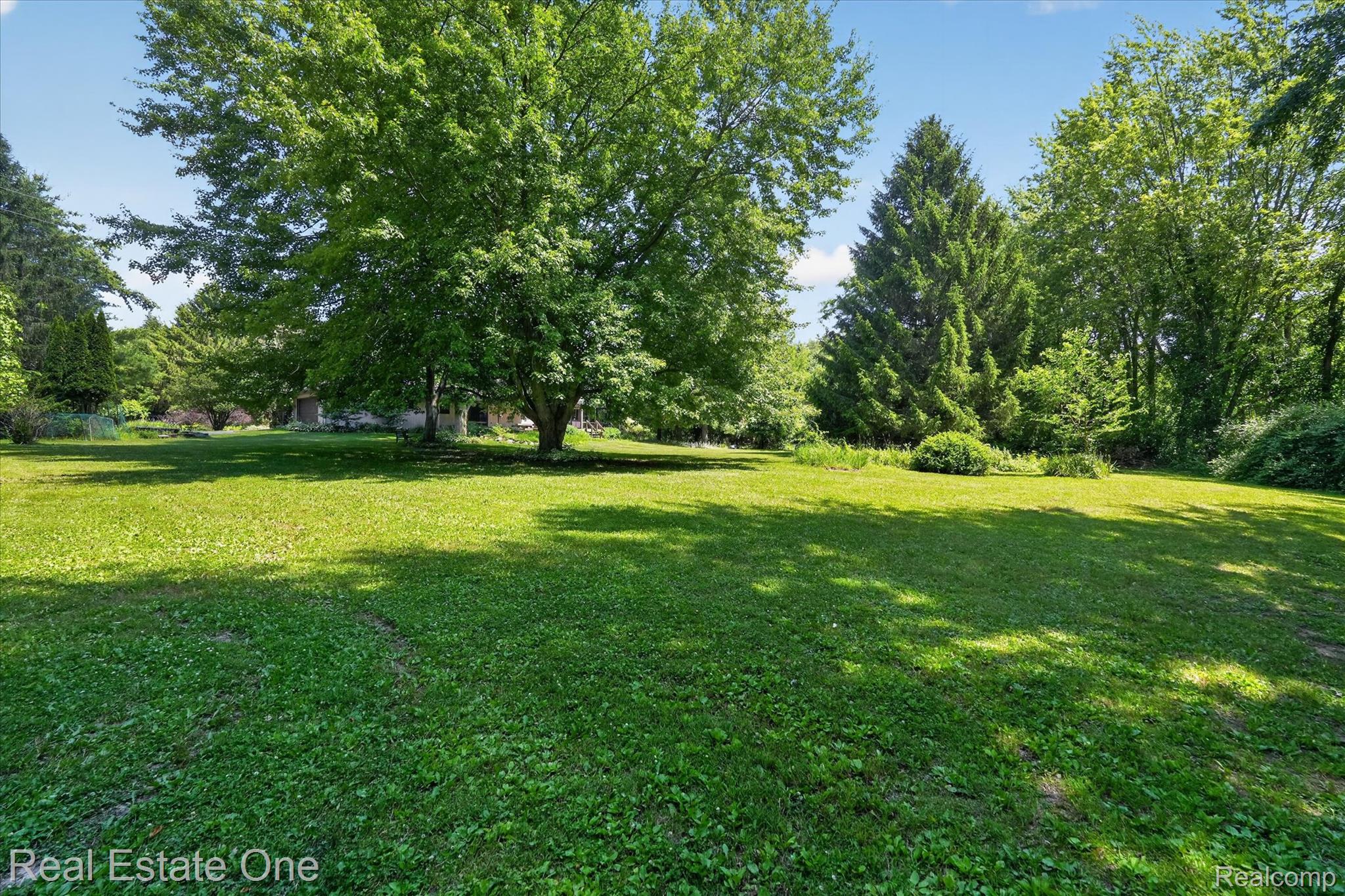 6039 Fish Lake Road Holly, MI 48442 - Photo 49 of 64 Expansive lawn area featuring mature trees and established perimeter landscaping