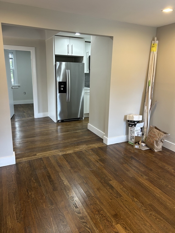9 Hawthorne Road, Unit 2 Gloucester, MA 01930 - Photo 2 of 9 a view of an empty room with wooden floor and a window