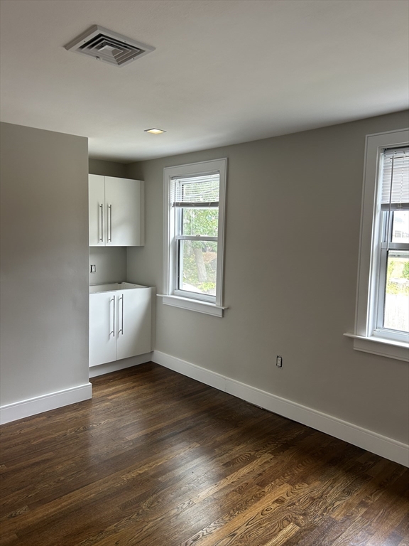 9 Hawthorne Road, Unit 2 Gloucester, MA 01930 - Photo 3 of 9 a view of an empty room with wooden floor and a window