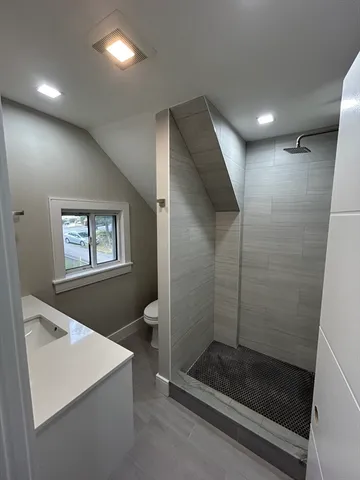 a bathroom with a shower and a sink