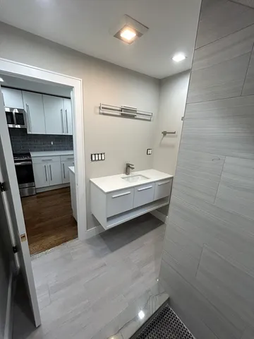 a bathroom with a sink a toilet and mirror