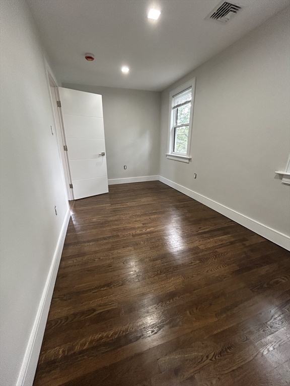 9 Hawthorne Road, Unit 2 Gloucester, MA 01930 - Photo 8 of 9 an empty room with wooden floor and window