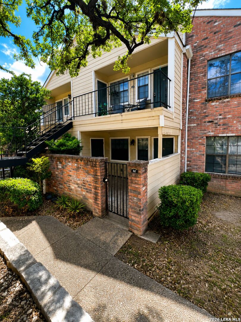 11610 Vance Jackson Road, Unit 867 San Antonio, TX 78230 - Photo 1 of 10 a front view of a house with a yard garage and outdoor seating