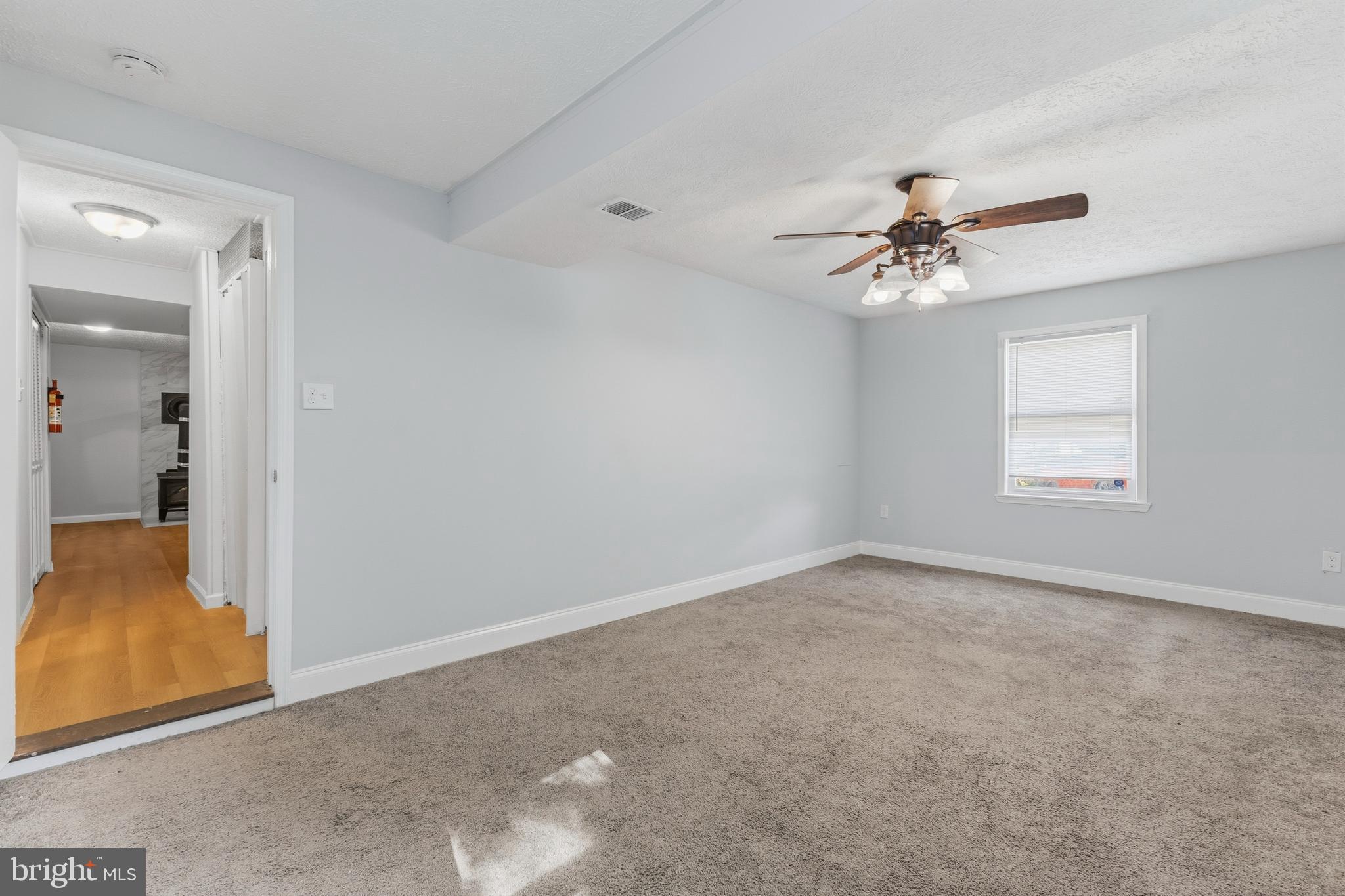 119 Jefferson Road Waldorf, MD 20602 - Photo 29 of 40 an empty room with chandelier fan and windows