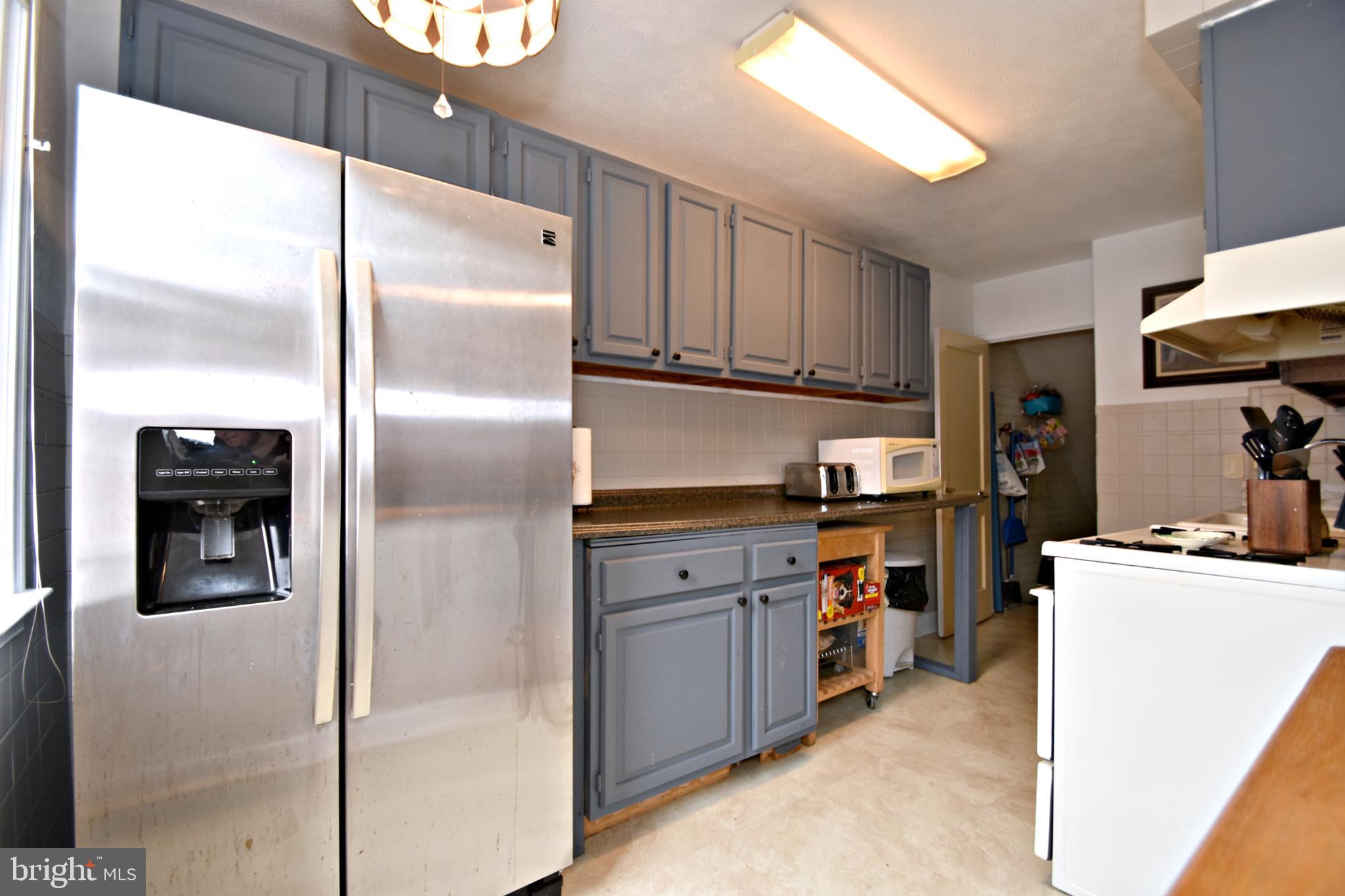 6622 Algard Street Philadelphia, PA 19135 - Photo 12 of 30 a kitchen with stainless steel appliances granite countertop a refrigerator and a stove