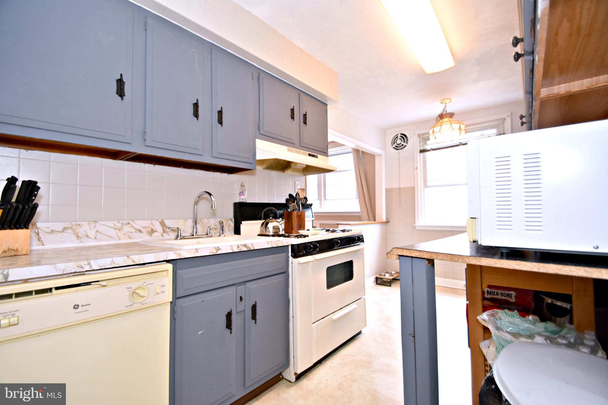 6622 Algard Street Philadelphia, PA 19135 - Photo 13 of 30 a kitchen with white cabinets and white appliances