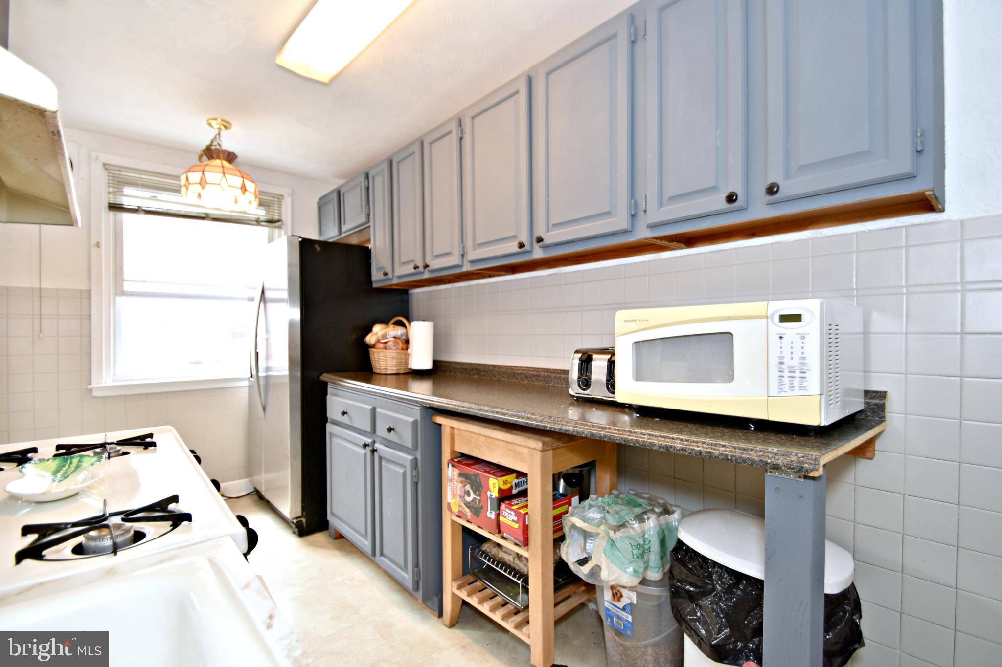 6622 Algard Street Philadelphia, PA 19135 - Photo 14 of 30 a kitchen with stainless steel appliances cabinets and a window