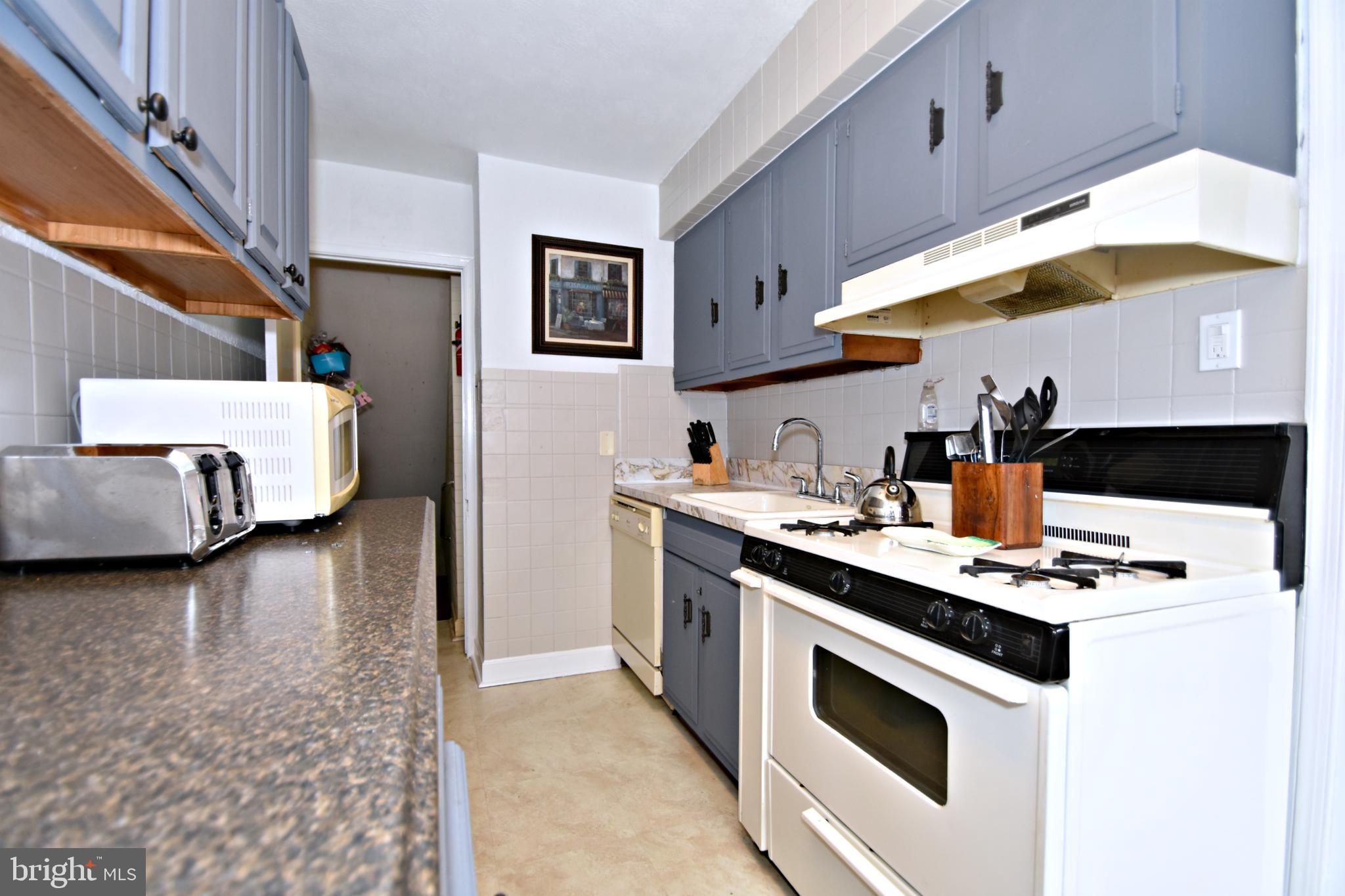 6622 Algard Street Philadelphia, PA 19135 - Photo 15 of 30 a kitchen with stainless steel appliances a stove a sink and a refrigerator