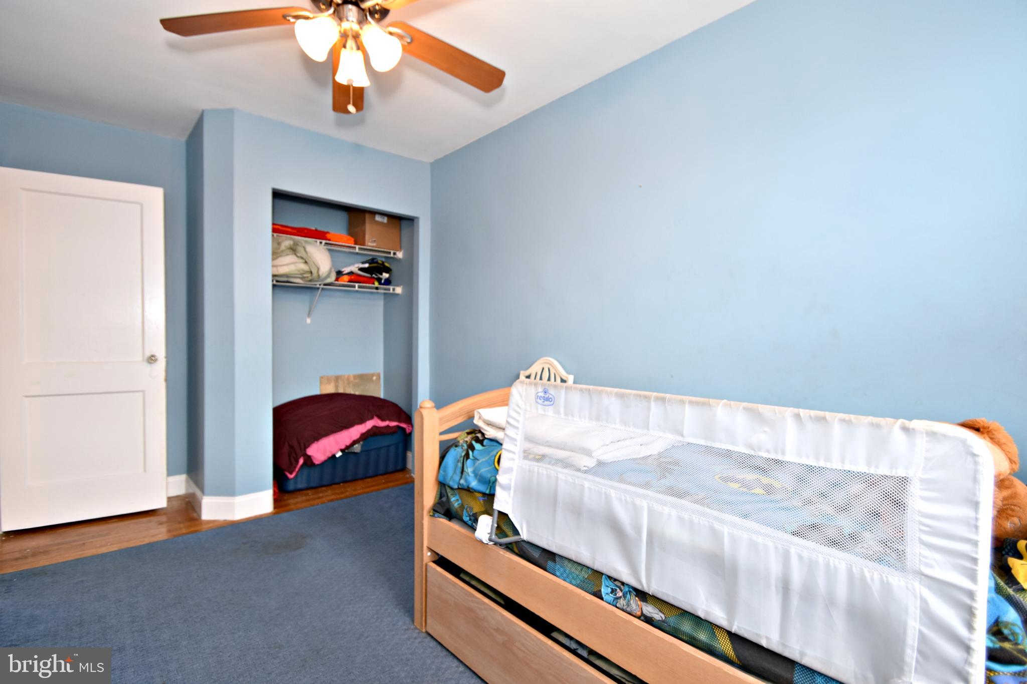 6622 Algard Street Philadelphia, PA 19135 - Photo 17 of 30 a bedroom with a bed and a chandelier