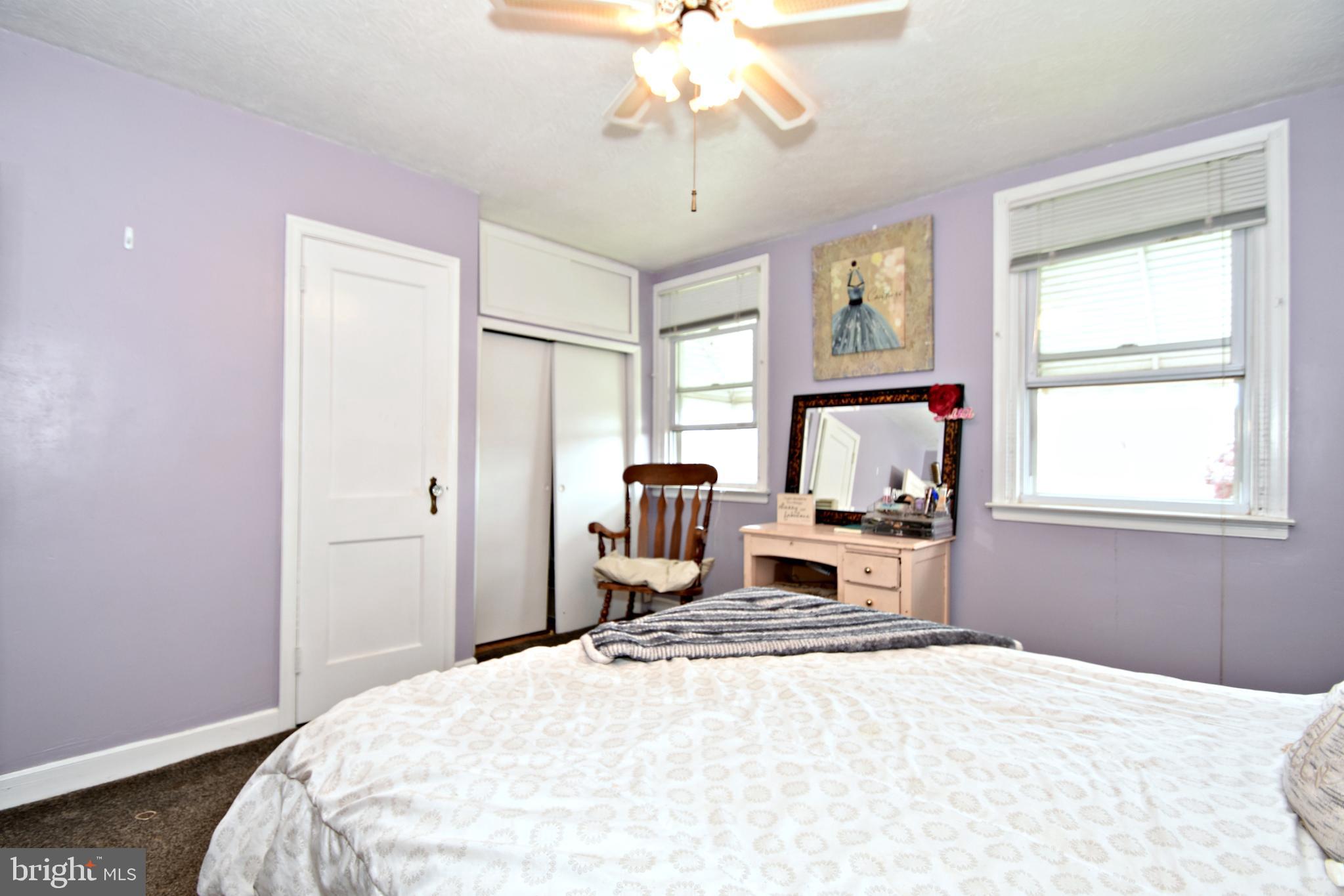 6622 Algard Street Philadelphia, PA 19135 - Photo 22 of 30 a bedroom with a bed and a chandelier