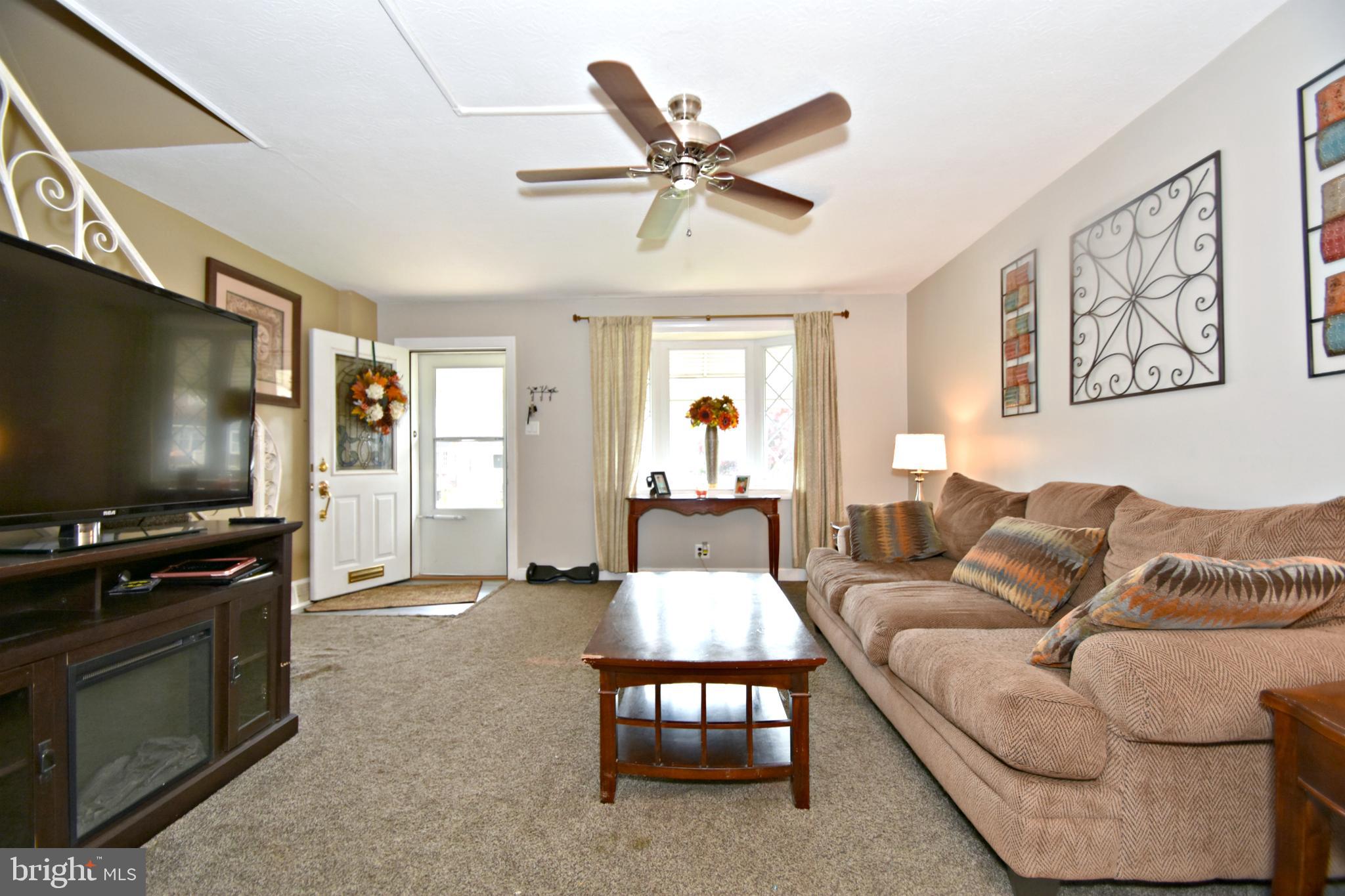 6622 Algard Street Philadelphia, PA 19135 - Photo 8 of 30 a living room with furniture and a flat screen tv