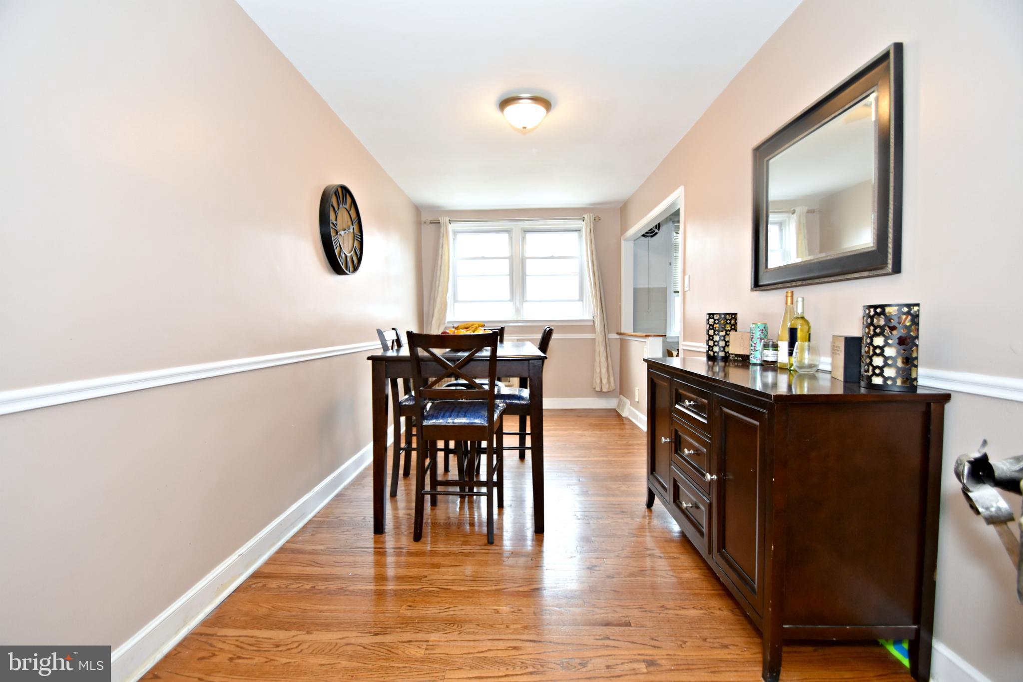 6622 Algard Street Philadelphia, PA 19135 - Photo 10 of 30 a dining room with chandelier and wooden floor