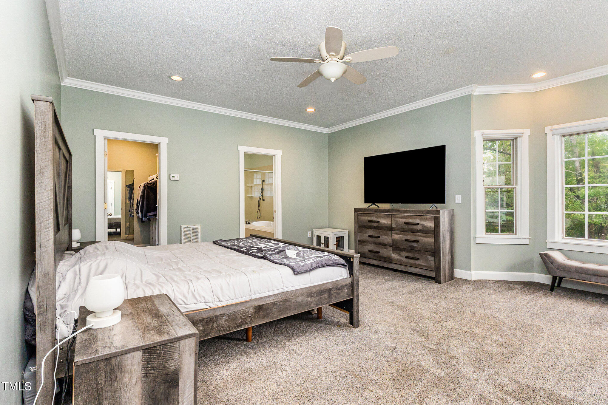 2215 Southern Road Sanford, NC 27330 - Photo 29 of 68 a spacious bedroom with a bed and a flat screen tv