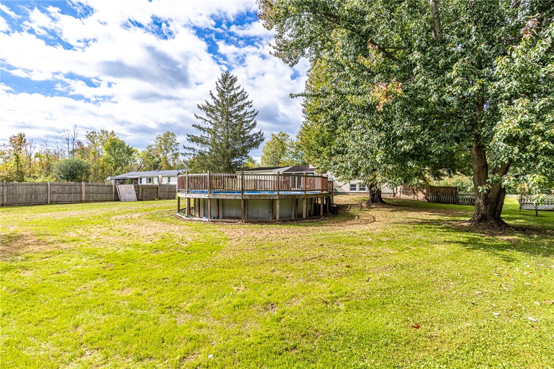 6432 Lakeside Road Ontario, NY 14519 - Photo 34 of 35 Mature trees shade a spacious lawn featuring an above ground pool with surrounding deck.