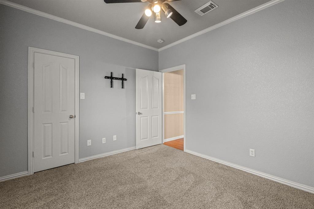 6501 Indian Trail Sanger, TX 76266 - Photo 15 of 40 Unfurnished bedroom with crown molding, carpet floors, and ceiling fan
