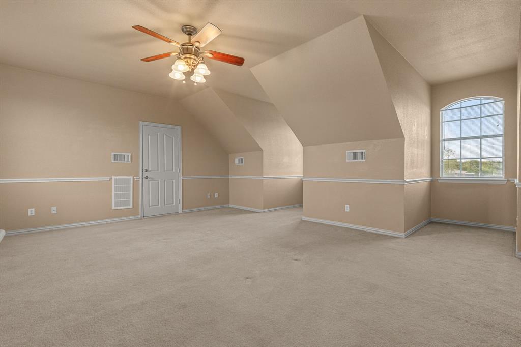 6501 Indian Trail Sanger, TX 76266 - Photo 26 of 40 Additional living space featuring light colored carpet, ceiling fan, and vaulted ceiling