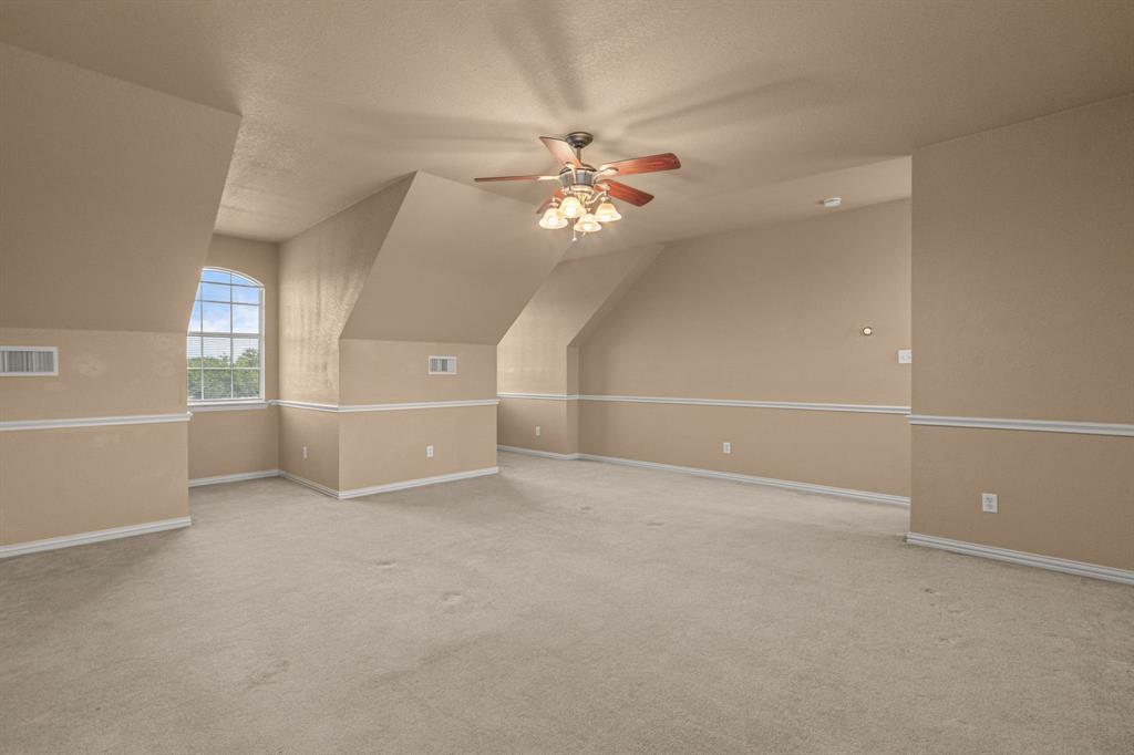 6501 Indian Trail Sanger, TX 76266 - Photo 28 of 40 Bonus room with lofted ceiling, light carpet, ceiling fan, and a textured ceiling