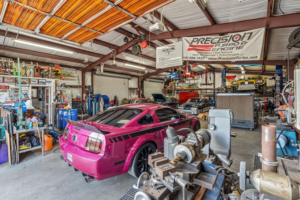6501 Indian Trail Sanger, TX 76266 - Photo 39 of 40 Garage with a workshop area, metal wall, and a garage door opener