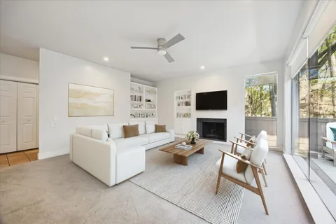 an empty room with fireplace and windows