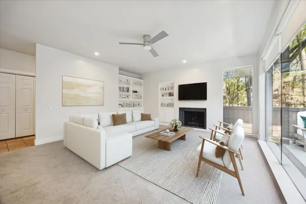 an empty room with fireplace and windows