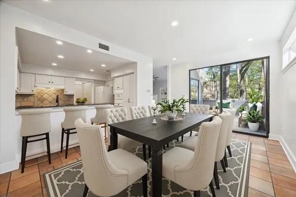 a kitchen with granite countertop white cabinets and black appliances