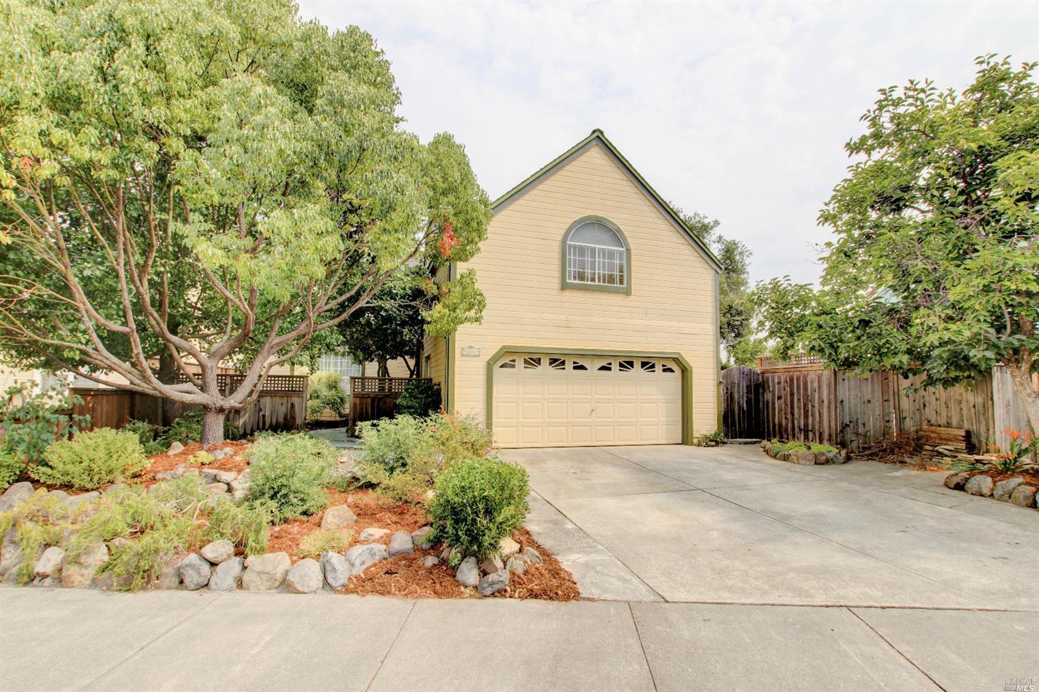 a view of a house with a yard and tree