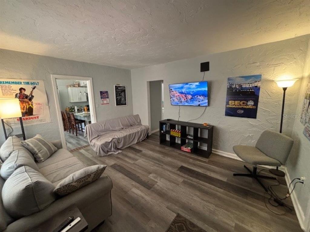 203 Northwest 25 Street Gainesville, FL 32607 - Photo 2 of 11 a living room with furniture and a flat screen tv