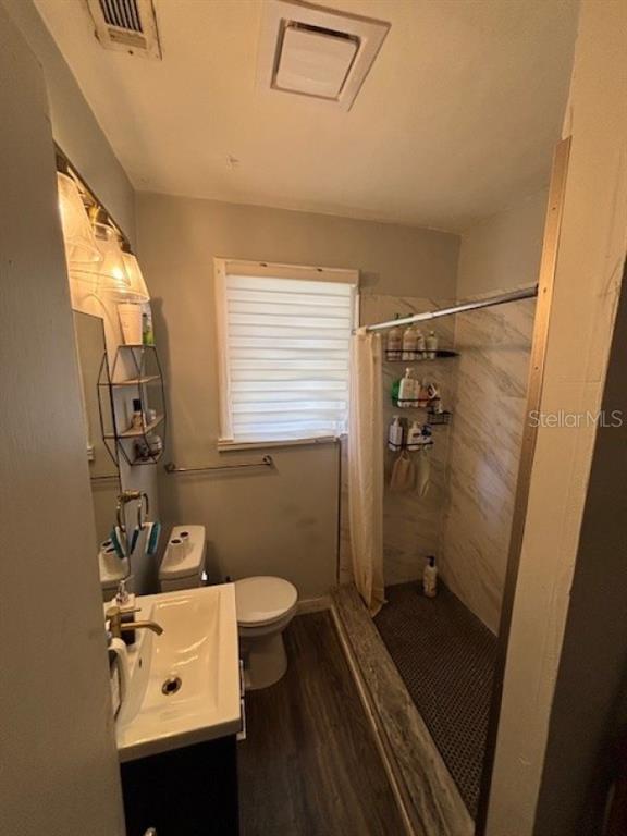 203 Northwest 25 Street Gainesville, FL 32607 - Photo 5 of 11 a bathroom with a sink a toilet and shower
