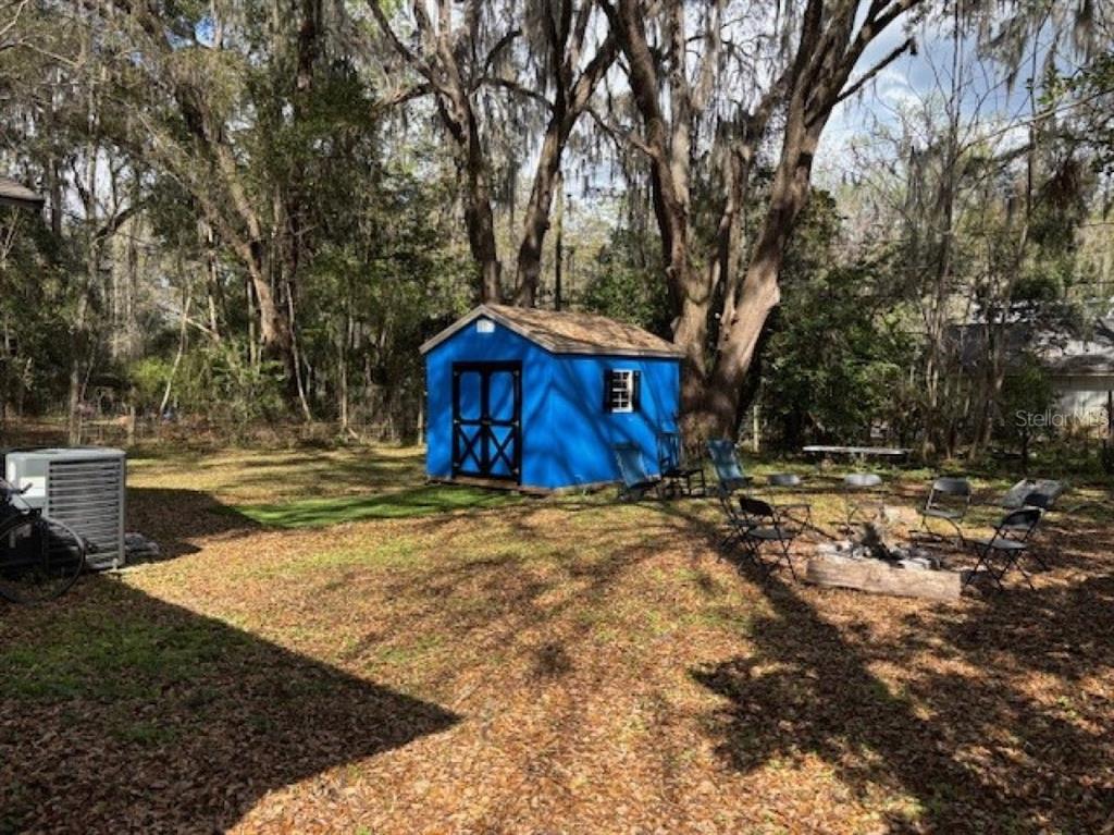 203 Northwest 25 Street Gainesville, FL 32607 - Photo 7 of 11 a view of a house with backyard and trees