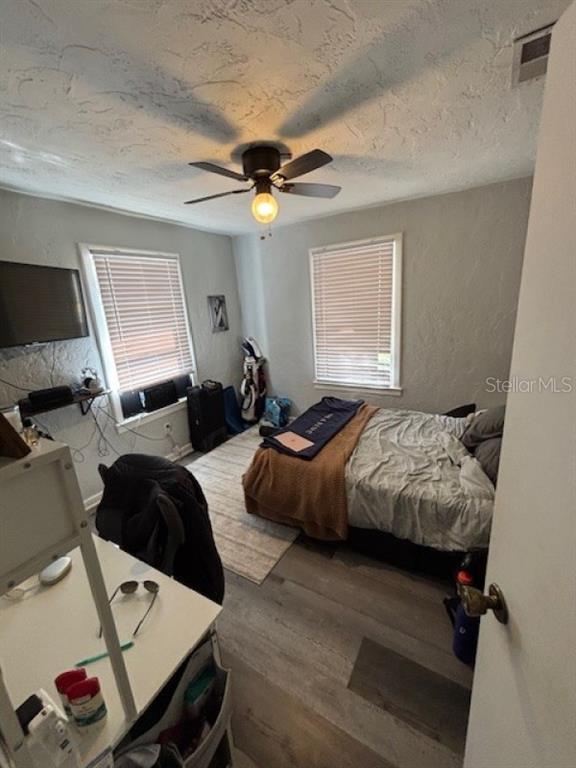 203 Northwest 25 Street Gainesville, FL 32607 - Photo 8 of 11 a bedroom with a bed and a window