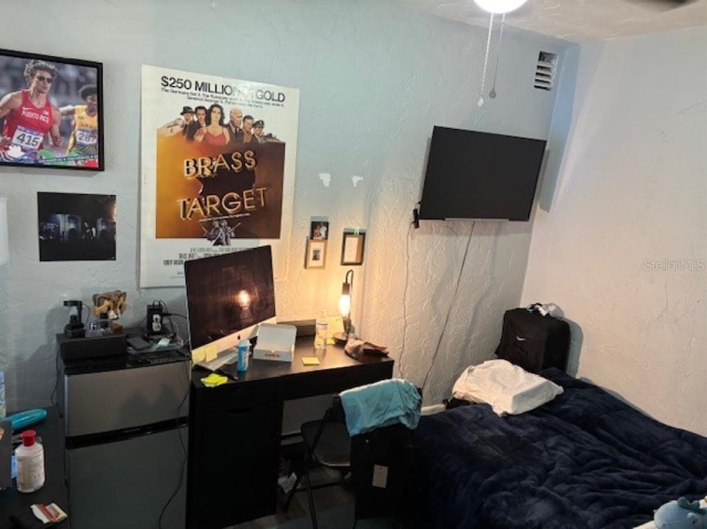 203 Northwest 25 Street Gainesville, FL 32607 - Photo 9 of 11 a living room with furniture and a flat screen tv