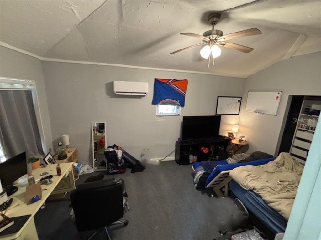 203 Northwest 25 Street Gainesville, FL 32607 - Photo 10 of 11 a room with furniture and a flat screen tv