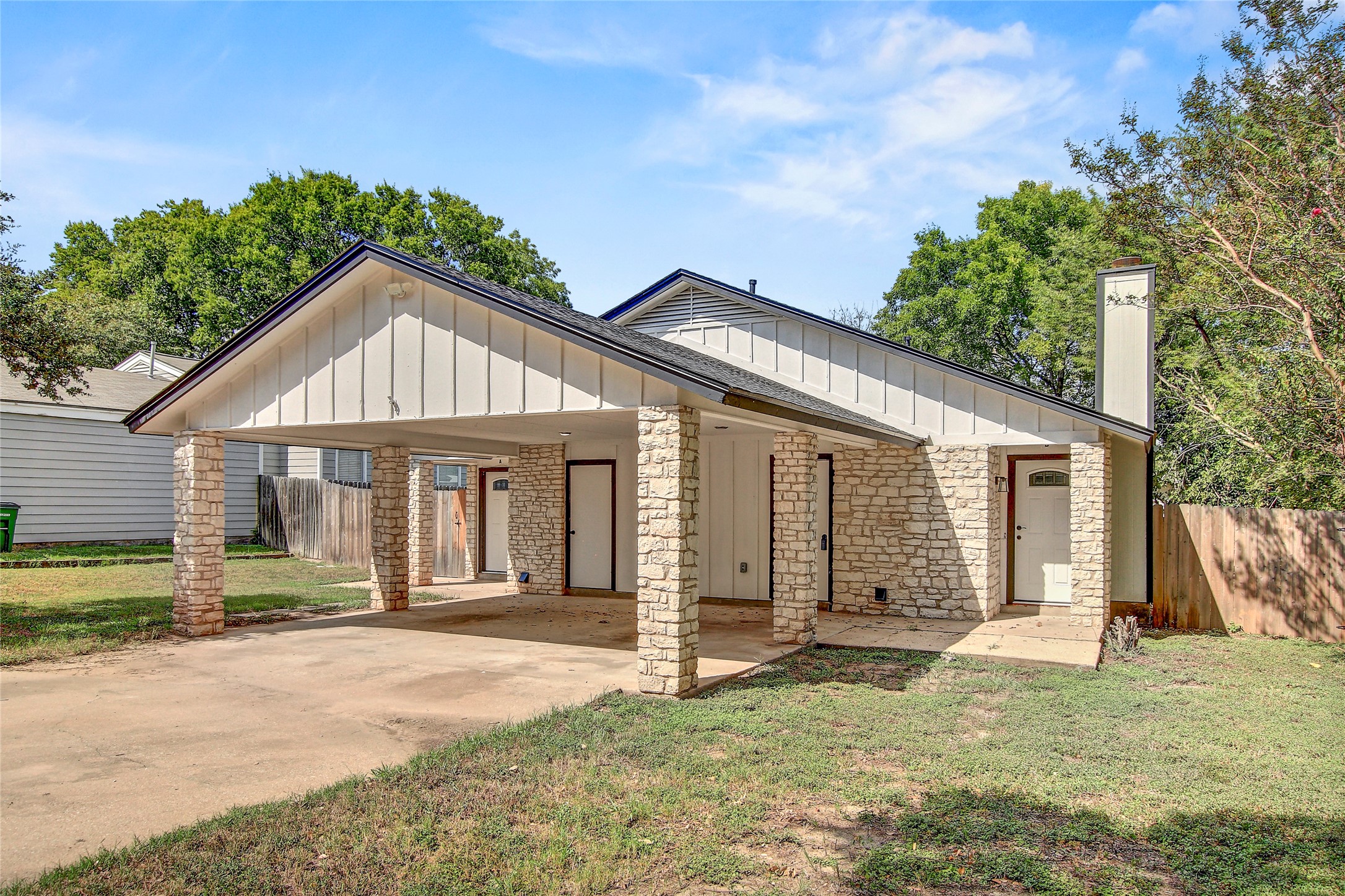 902 King Albert Street, Unit B Austin, TX 78745 - Photo 1 of 16 View of front of home featuring board and batten siding, concrete driveway, and a carport